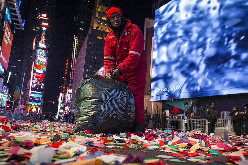 A sanitation worker begins cleaning Times Square after a New Years Eve celebration, Thursday, Jan. 1, 2015, in New York. Thousands braved the cold to watch the annual ball drop and ring in the new year. 