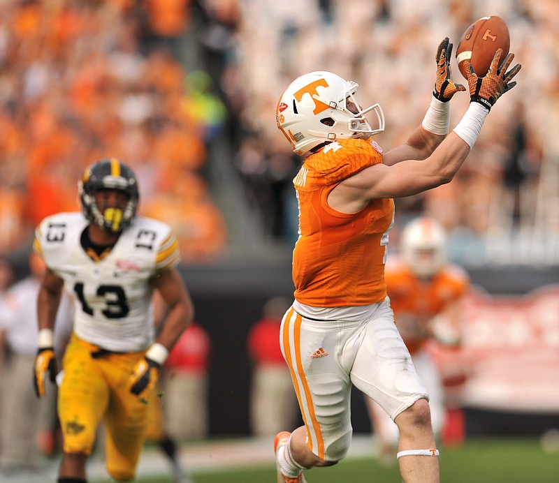 Tennessee's Vic Wharton pulls in a long pass for a touchdown during the TaxSlayer Bowl NCAA college football game against Iowa, on Jan. 2, 2015, in Jacksonville, Fla. 