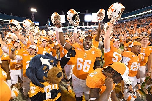 Tennessee's Marques Pair (66) and teammates sing with the band after the TaxSlayer Bowl on Friday, Jan. 2, 2015, in Jacksonville, Fla. Tennessee won 45-28. 