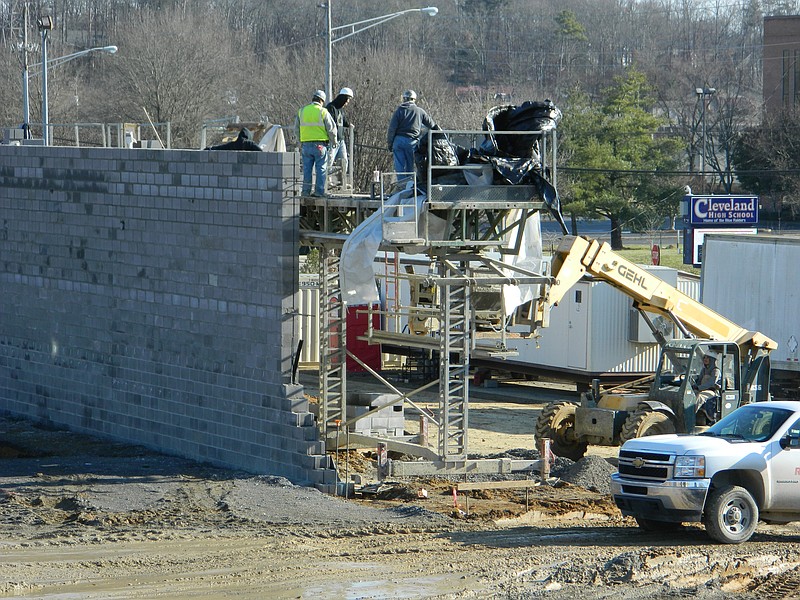 A new wall is underway on the southern perimeter of the site of Cleveland High School's new gymnasium. The Cleveland School Board will consider naming the new facility "Raider Arena" on Monday.
