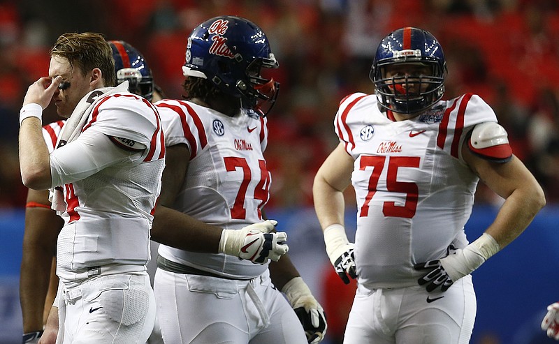 Ole Miss quarterback Bo Wallace, left, was intercepted three times as the Rebels were overwhelmed by TCU, 42-3, in last Wednesday's Peach Bowl in Atlanta.