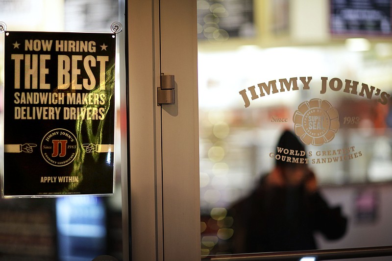 A sign advertises hiring opportunities at a Jimmy John's sandwich shop in this file photo.