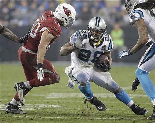 Carolina Panthers' Jonathan Stewart (28) runs as Arizona Cardinals' Larry Foote (50) defends in their NFL wild card playoff game in Charlotte, N.C., Saturday, Jan. 3, 2015.