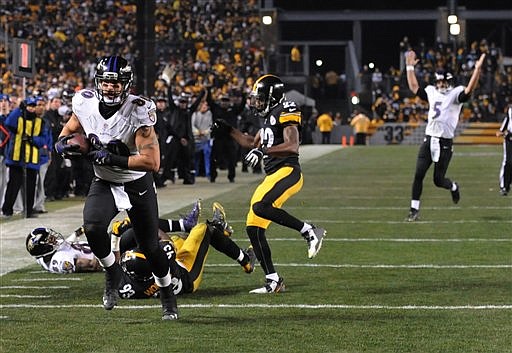 Baltimore Ravens tight end Crockett Gillmore (80) heads for the end zone and a touchdown in the fourth quarter of their NFL wildcard playoff  game against the Pittsburgh Steelers, Saturday, Jan. 3, 2015, in Pittsburgh. 