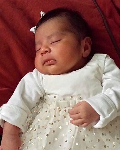 Missing baby Eliza Delacruz is seen in an undated photo provided by the Long Beach Police Department. Long Beach police say 3-week-old Eliza Delacruz is missing from a home where the baby's mother, father and uncle were found shot. 