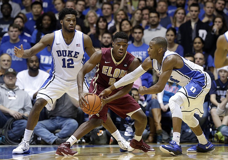 Duke's Justise Winslow (12) and Rasheed Sulaimon, right, guard Elon's Dmitri Thompson (2) during the second half of an NCAA college basketball game in Durham, N.C., on Monday, Dec. 15, 2014. Duke won 75-62.