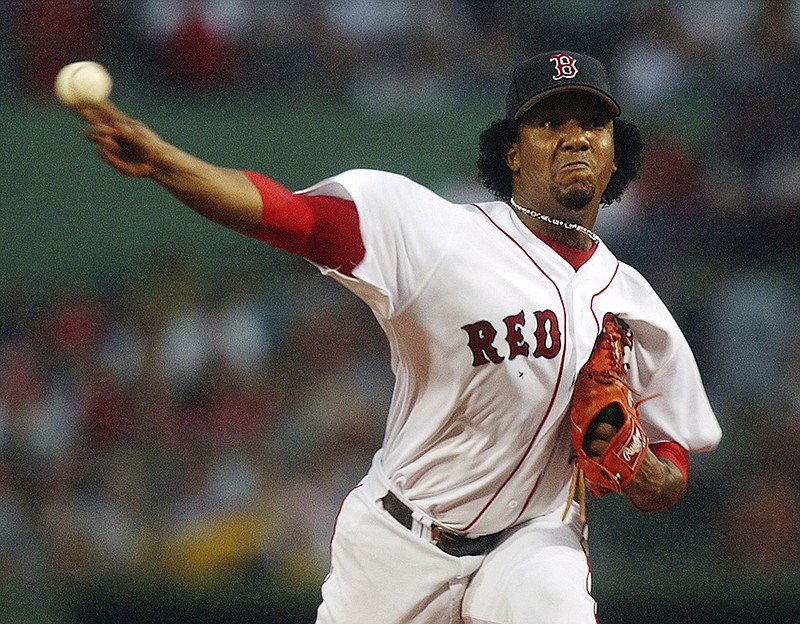 In this June 25, 2004, file photo, Boston Red Sox starting pitcher Pedro Martinez delivers during the first inning of a Major League baseball game against the Philadelphia Phillies at Fenway Park in Boston.
