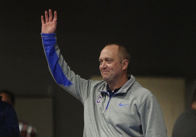 New Cleveland football coach Scott Cummings raids his hand as he is introduced before the Cleveland-Bradley Central high school wrestling meet Tuesday, Jan. 6, 2015, at Cleveland Middle School in Cleveland, Tenn. (Staff Photo by Doug Strickland)