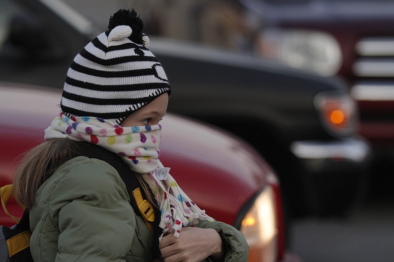 Isabella Rutkowski wears her scarf over her face to stay warm as she walks into Battle Academy.