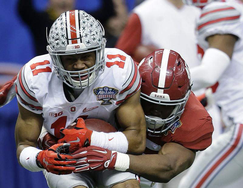 Ohio State defensive back Vonn Bell (11) is tackled by Alabama running back Jalston Fowler (45) after intercepting a pass in the second half of the Sugar Bowl in New Orleans.