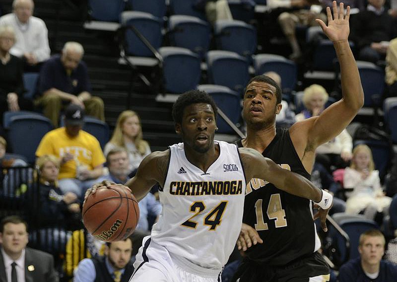 UTC's Casey Jones drives toward the basket past Spencer Collins during the Mocs' loss to Wofford in the Southern Conference game Monday at McKenzie Arena. (Staff Photo by Logan Foll)