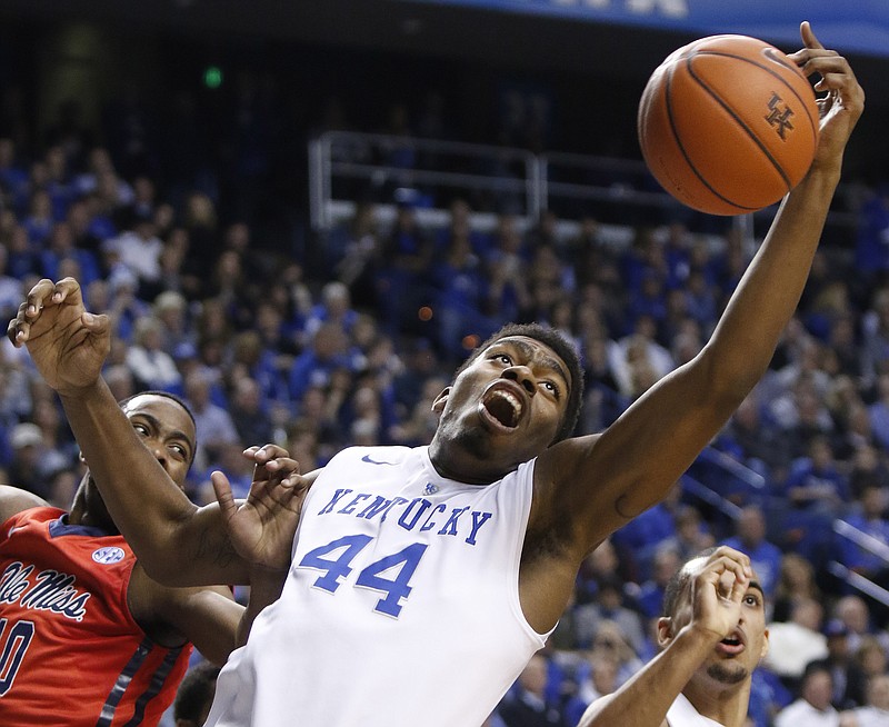 
              Kentucky's Dakari Johnson (44) reaches for a rebound next to Mississippi's LaDarius White during the first half of an NCAA college basketball game in Lexington, Ky., Tuesday, Jan. 6, 2015. (AP Photo/James Crisp)
            