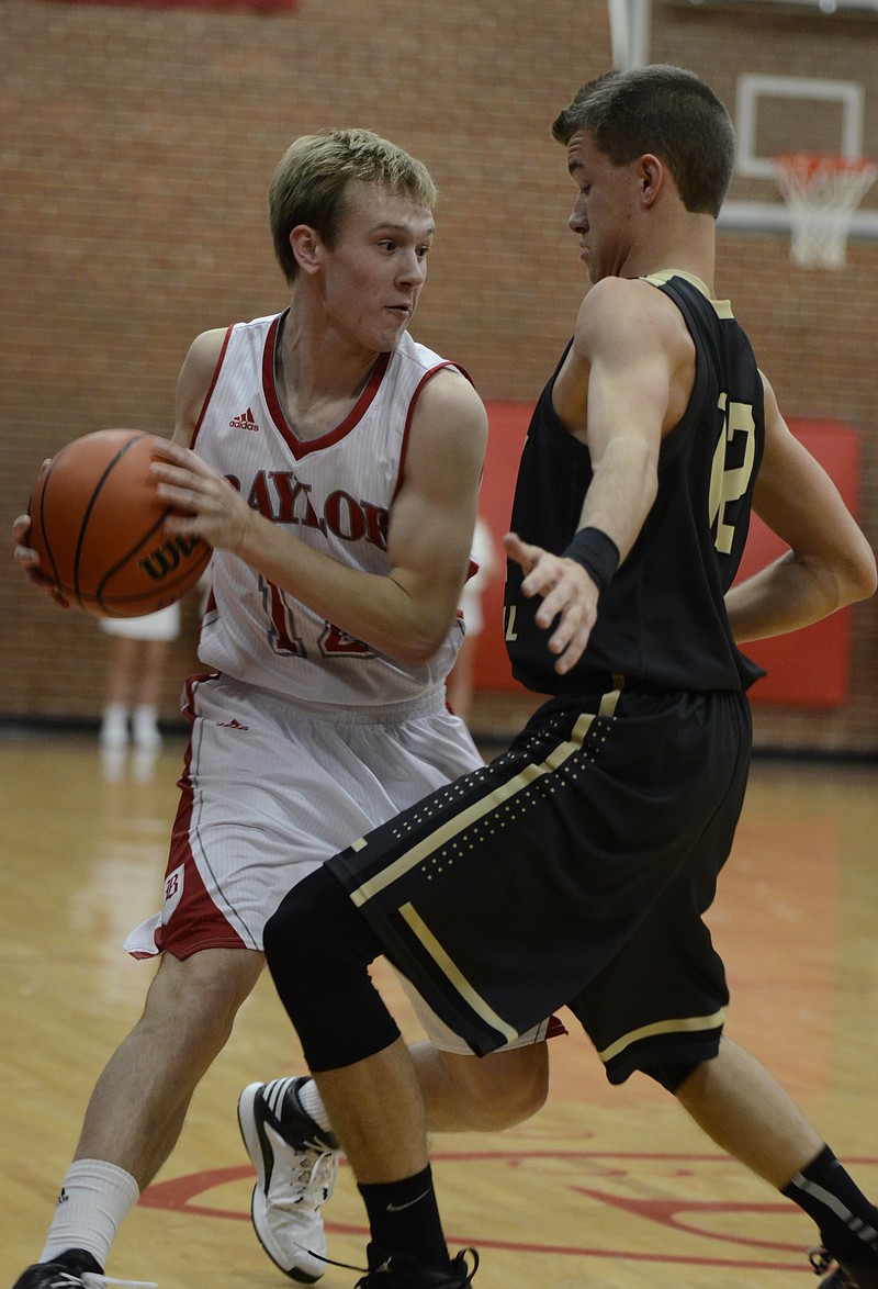 Baylor's Austin Maize drives towards the basket against Bradley Central's Tucker Maroon Wednesday at Baylor High School.