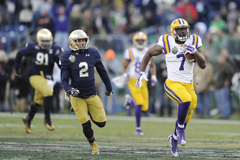 
              FILE - In this Dec. 30, 2014, file photo, LSU running back Leonard Fournette (7) gets past Notre Dame's Cody Riggs (2) as Fournette returns a kickoff 100 yards for a touchdown in the second quarter of the Music City Bowl NCAA college football game in Nashville, Tenn. Following the 38 postseason games with "bowl" in the title, Fournette was chosen as one of the best of the best by a panel of AP writers who cover college football.  (AP Photo/The Tennessean, Shelley Mays, File) NO SALES
            