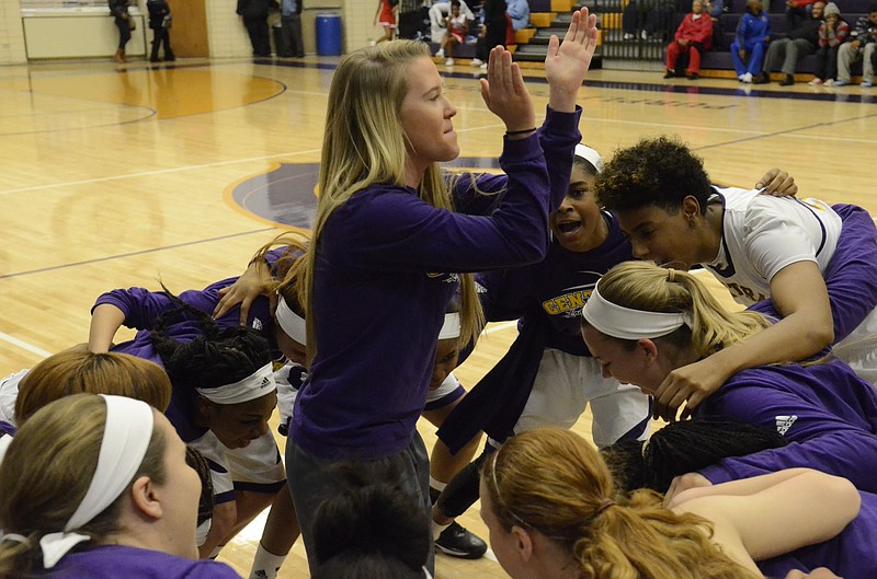 Madison Rogers, center, claps as she stands in the middle of the Central High School basketball team after warm-ups before their game with Brainerd Tuesday, Dec. 16, 2014, in Chattanooga, Tenn. Rogers is out for the season with a knee injury. 