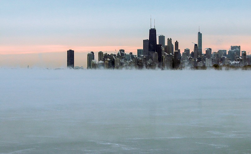 Steam rises over Lake Michigan near the Chicago skyline, Thursday, Jan. 8, 2015. Dangerously cold air has sent temperatures plummeting into the single digits around the U.S., with wind chills driving them even lower.
