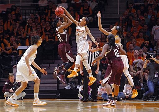 Tennessee guard Andraya Carter (14) blocks the shot of Texas A&M guard Courtney Walker (33) in their game Thursday, Jan. 8, 2015, in Knoxville.