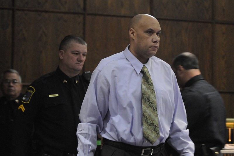 Adolphus Hollingsworth is escorted into Judge Rebecca Stern's courtroom Friday before the jury decision is announced. Hollingsworth was convicted of the second degree murder in the death of his wife in 1997.