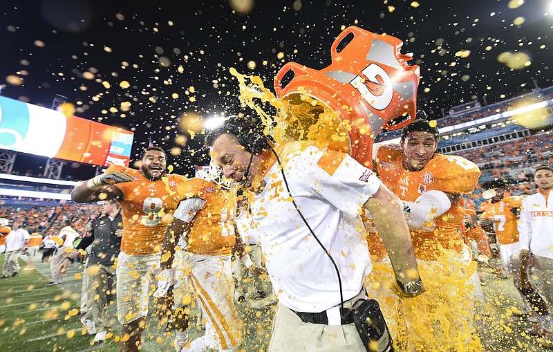 Tennessee coach Butch Jones is doused as the team defeats Iowa 45-28 in the TaxSlayer Bowl on Jan. 2 in
Jacksonville, Fla. 