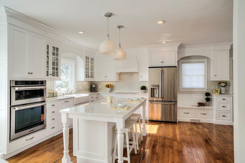 Although more than 70 percent of kitchens remodeled in 2014 were done in white, author Brian Wansink advises against a white kitchen due to what he believes is its tendency to stimulate the appetite. Even so, white kitchens remain a top choice of local homeowners, says Becky Worley, owner of Classic Cabinetry. In the remodel of this East Ridge home by Classic Cabinetry, the original oak flooring was kept but refinished. Maple cabinets were painted white with recessed, flat-panel doors and white Carrara quartz countertops installed.
Photo by Med Dement