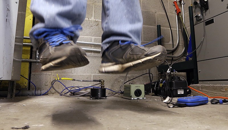 
              As several pieces of seismic monitoring equipment sit on the floor, a scientist does a "stomp test" to check the gear at the Seattle Seahawks' field, CenturyLink Field, Thursday, Jan. 8, 2015, in Seattle. Scientists with the Pacific Northwest Seismic Network installed the instruments to record expected vibrations from jumping and stomping fans at Saturday's Seahawks playoff game against the Carolina Panthers. The work follows the "beast quake" that was generated by a Marshawn Lynch "Beast Mode" touchdown run on Jan. 8, 2011, and recorded on a seismometer in Seattle. (AP Photo/Elaine Thompson)
            