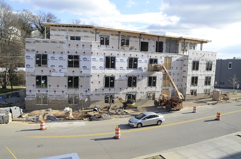 A car maneuvers between traffic barrels in front of The Lofts on Tremont being built by Wise Properties.