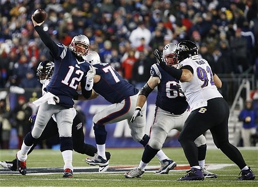 New England Patriots quarterback Tom Brady (12) passes over Baltimore Ravens defensive end Haloti Ngata (92) in their game Saturday, Jan. 10, 2015, in Foxborough, Mass.