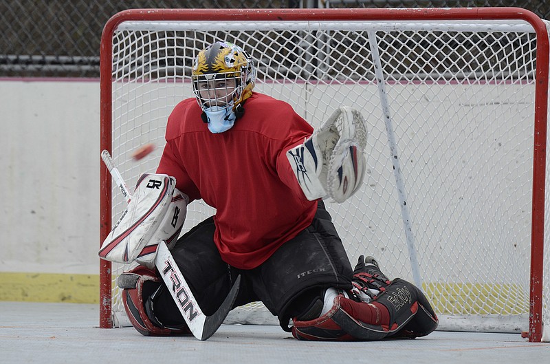 Goalie Andrew Sowder attempts to block a shot Sunday while practicing for a roller hockey league starting in two weeks at Chattown Skate Park.