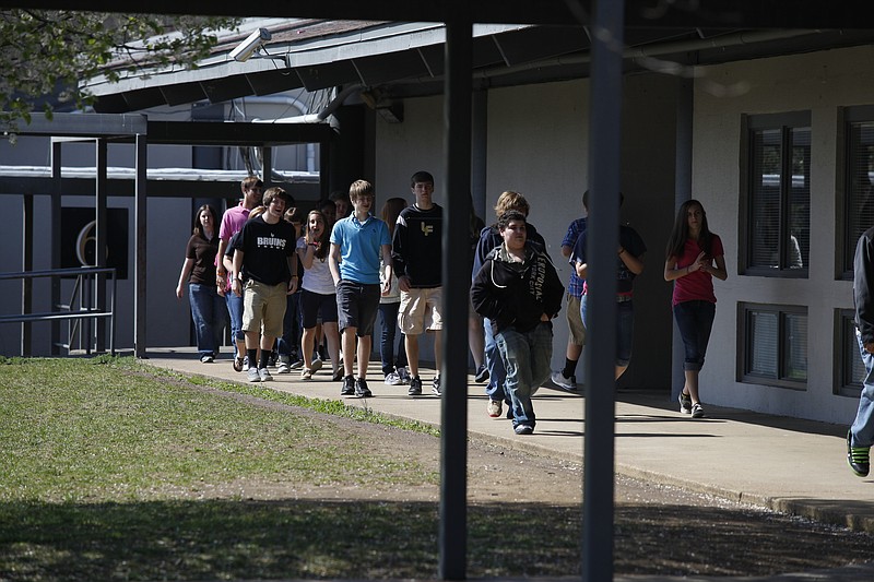 Children walk between classroom buildings at Lake Forest Middle School in Cleveland in this 2012 photo.
