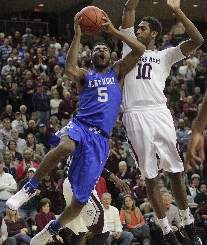 Kentucky's Andrew Harrison (5) takes a shot over Texas A&M's Jordan Green (10) during the second half of the top-ranked Wildcats' double-overtime win Saturday at College Station, Texas.