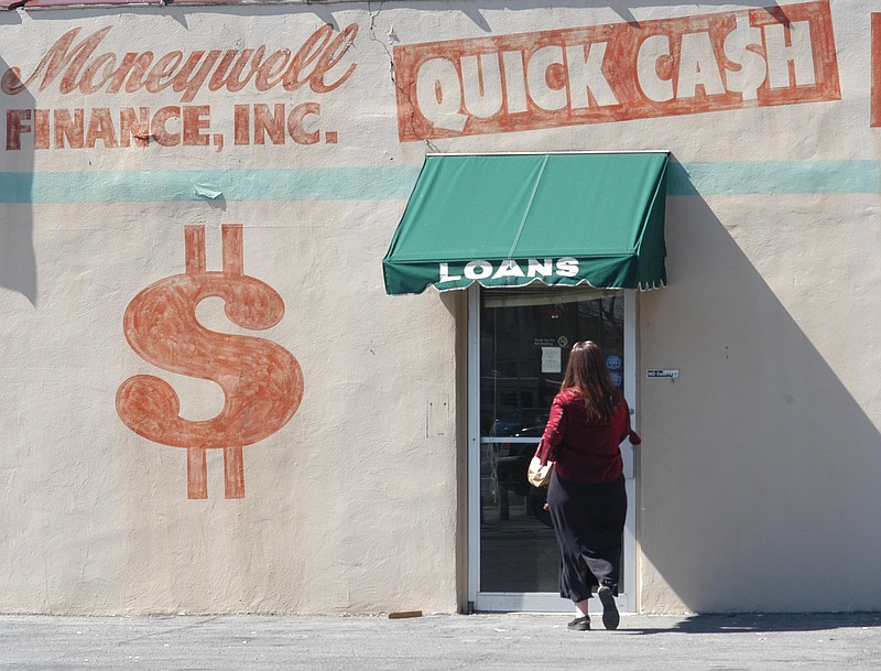 A woman walks into a Moneywell Finance, Inc. building in this file photo.
