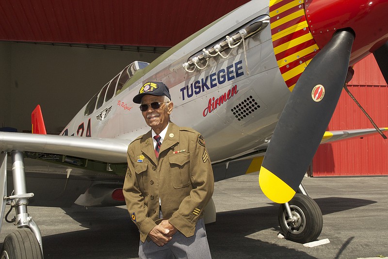 
              This April 7, 2011 photo by Bruce Talamon shows Clarence E. "Buddy" Huntley Jr., a member of the Tuskegee Airmen, the famed all-black squadron that flew in World War II, posing with a P-51C Mustang fighter plane similar to the one that he was a crew chief on while overseas during the war, at Torrance, Calif., Airport. Huntley and fellow Tuskegee Airman Joseph Shambrey, lifelong friends who enlisted together, both died on the same day, Monday, Jan. 5, 2015, in their Los Angeles homes, relatives said Sunday, Jan. 11, 2015. Both were 91. Huntley and Shambrey enlisted in 1942 and were shipped overseas to Italy in 1944 with the 100th Fighter Squadron of the Army Air Force's 332nd Fighter Group. As mechanics, they kept the combat planes flying.(AP Photo/Bruce Talamon (c) 2011 All Rights Reserved)
            