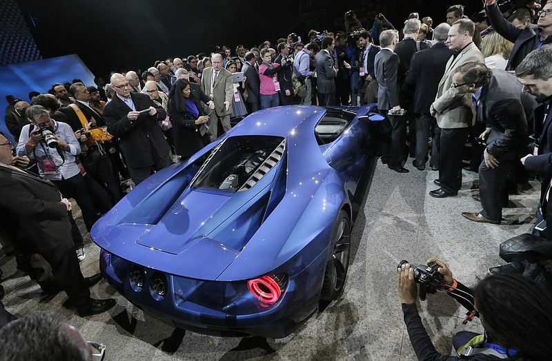 
              Journalists surround the new Ford GT after it was unveiled at the North American International Auto Show, Monday, Jan. 12, 2015 in Detroit. (AP Photo/Carlos Osorio)
            