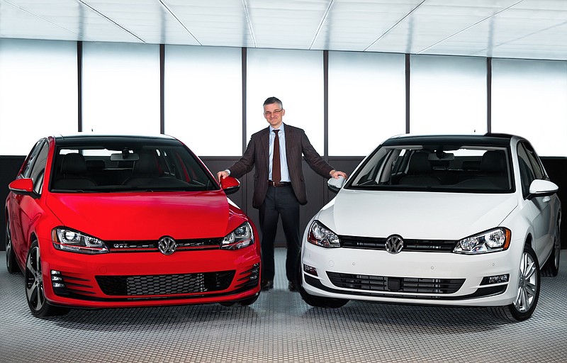 Michael Horn, CEO, Volkswagen Group of America, is pictured with the Golf and Golf GTI in this contributed photo from VW.