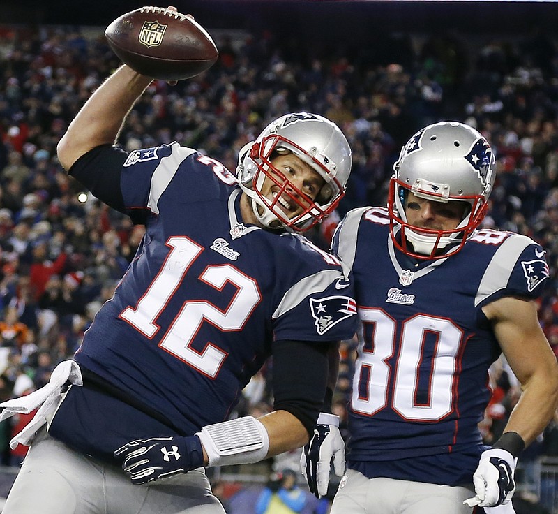 
              FILE - In this Nov. 2, 2014, file photo, New England Patriots quarterback Tom Brady (12) celebrates with wide receiver Danny Amendola (80) in the first half of an NFL football game against the Denver Broncos in Foxborough, Mass. All four teams in this weekend's conference championships navigated a winding road. (AP Photo/Elise Amendola, File)
            