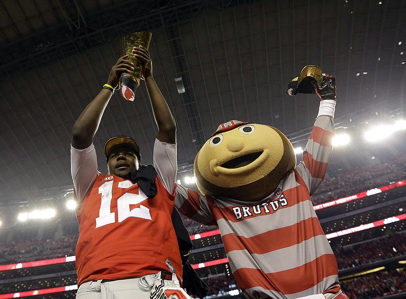 
              Ohio State's Cardale Jones and their mascot celebrate after the NCAA college football playoff championship game against Oregon Monday, Jan. 12, 2015, in Arlington, Texas. Ohio State won 42-20. (AP Photo/David J. Phillip)
            