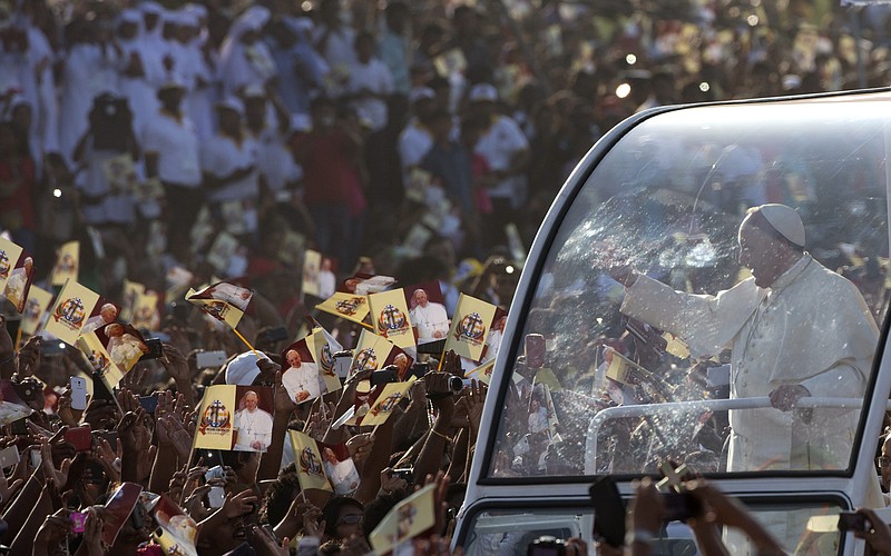 
              Pope Francis, right, arrives in Colombo's seafront Galle Face Green for the  canonization ceremony of Joseph Vaz, Wednesday, Jan. 14, 2015. Pope Francis pressed his call for Sri Lankan unity and reconciliation Wednesday with the Mass in Colombo to canonize the country's first saint and a visit to the war-ravaged north to pray at a shrine revered by both Sinhalese and Tamil faithful. (AP Photo/Alessandra Tarantino)
            