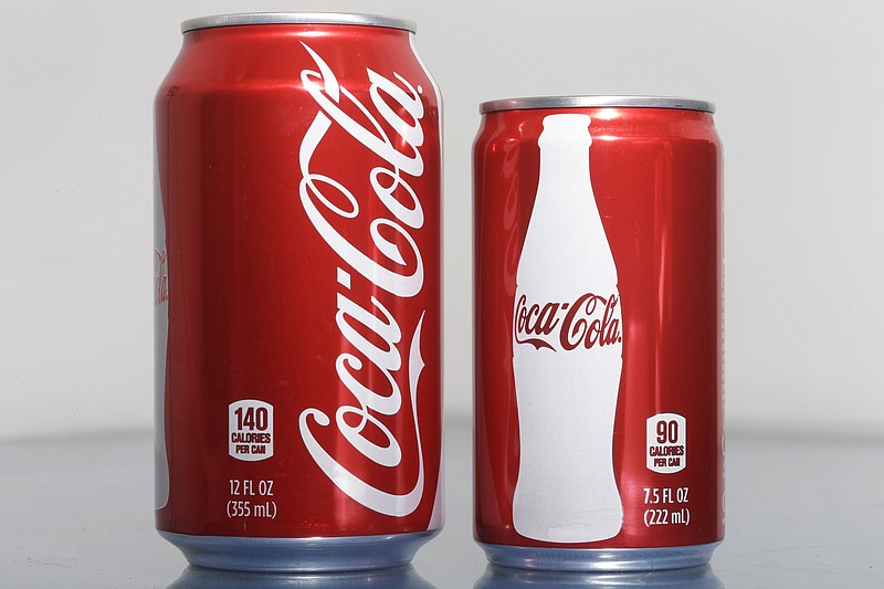 A 7.5-ounce can of Coca-cola, right, is posed next to a 12-ounce can for comparison Monday, Jan. 12, 2015, in Philadelphia. 