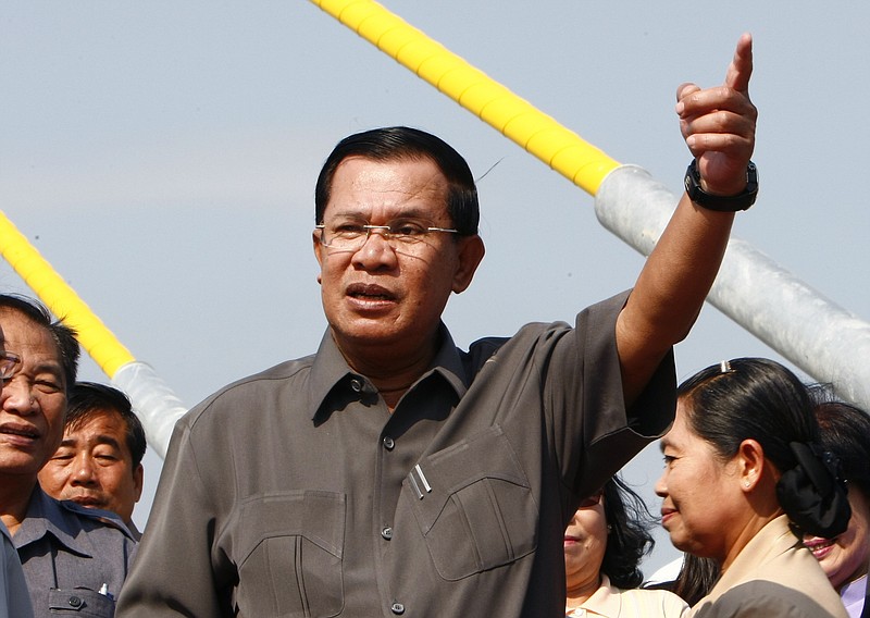 
              Cambodia's Prime Minister Hun Sen, center, gestures during a ceremony inaugurating the country's longest bridge in Neak Loeung, southeast of Phnom Penh, Cambodia, Wednesday, Jan. 14, 2015. Hun Sen, Cambodia's tough and wily prime minister, marks 30 years in power Wednesday, one of only a handful of political strongmen worldwide who have managed to cling to their posts for three decades. (AP Photo/Heng Sinith)
            