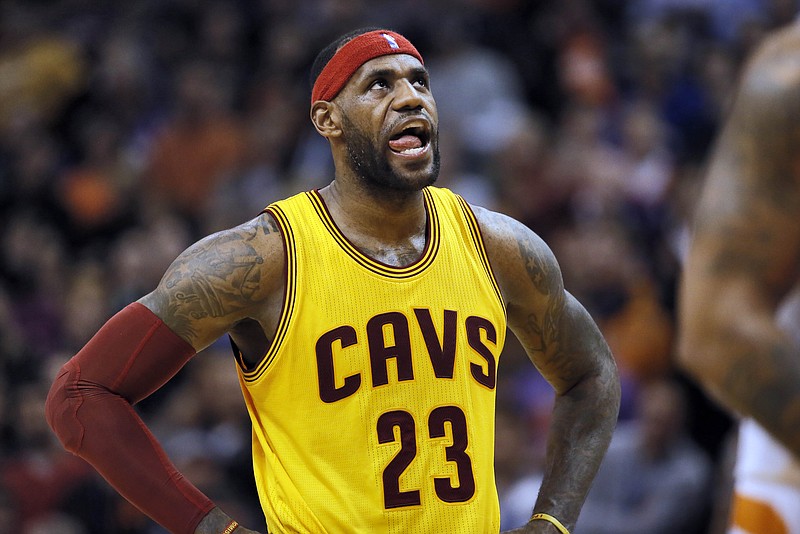 Cleveland Cavaliers' LeBron James looks at the scoreboard during the Cavaliers' game against the Phoenix Suns on Jan. 13, 2015, in Phoenix. The Suns won 107-100. (