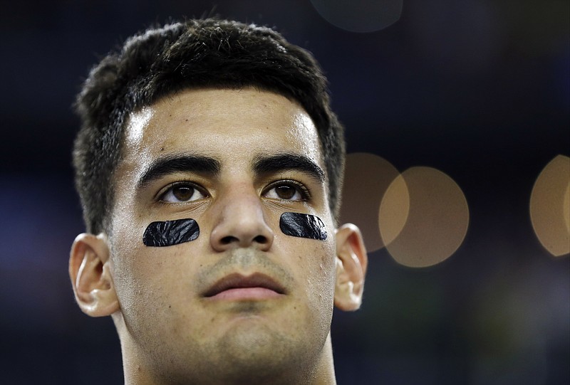 
              Oregon's Marcus Mariota during the national anthem before the NCAA college football playoff championship game against Ohio State Monday, Jan. 12, 2015, in Arlington, Texas. (AP Photo/David J. Phillip)
            