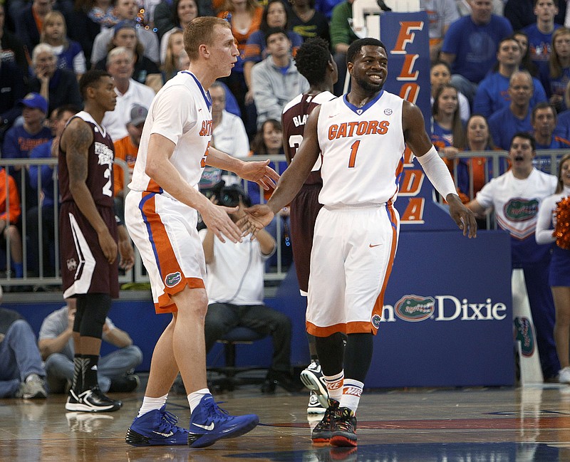 Florida forward Alex Murphy (5) and guard Eli Carter (1) celebrate after a play against Mississippi State during their game on Jan. 10, 2015, in Gainesville, Fla. Florida defeated Mississippi State 72-47.