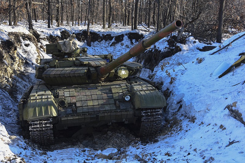 
              In this Wednesday, Jan. 14, 2015 photo Russian-backed separatist's tank is placed in a fortified position at the check-point north of Luhansk, Eastern Ukraine.  An attack on a passenger bus in eastern Ukraine killed 12 people Tuesday, likely dealing the final blow to hopes that a short-lived and shaky cease-fire could take hold. (AP Photo/ Mstyslav Chernov)
            