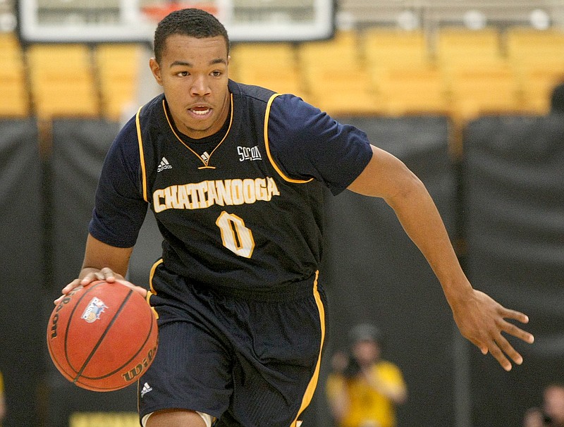 Chattanooga forward Chuck Ester (0) drives the ball at Kennesaw State University's Convocation Center in Kennesaw, Ga.