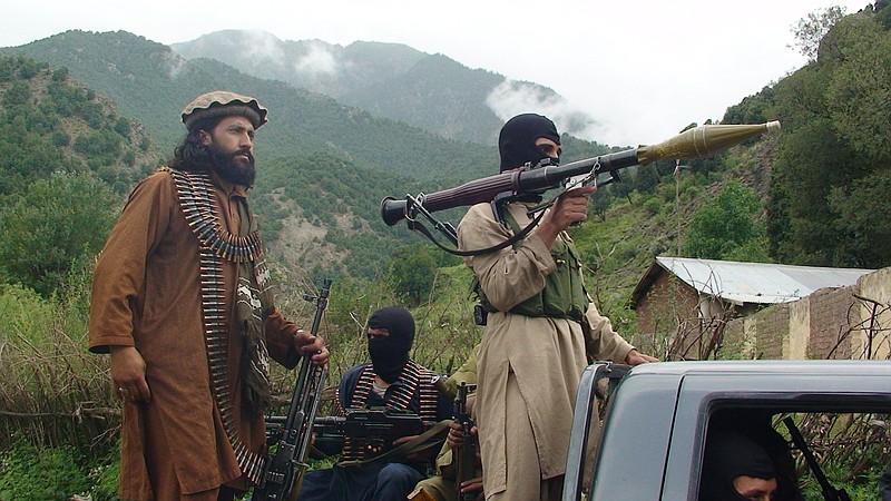 
              FILE  - In this file photo taken on Sunday, Aug. 5, 2012, Pakistani Taliban patrol in their stronghold of Shawal in Pakistani tribal region of South Waziristan. Interior Minister Chaudhry Nisar Ali Khan said in November 2014 there was no Islamic State group presence, only militants using its name. However, a letter written by the federal government a month earlier and later obtained by The Associated Press warned local officials that the Islamic State group had begun courting area militants and that the extremists claimed the support of up to "12,000 followers" in northwest Pakistan. (AP Photo/Ishtiaq Mahsud, File)
            