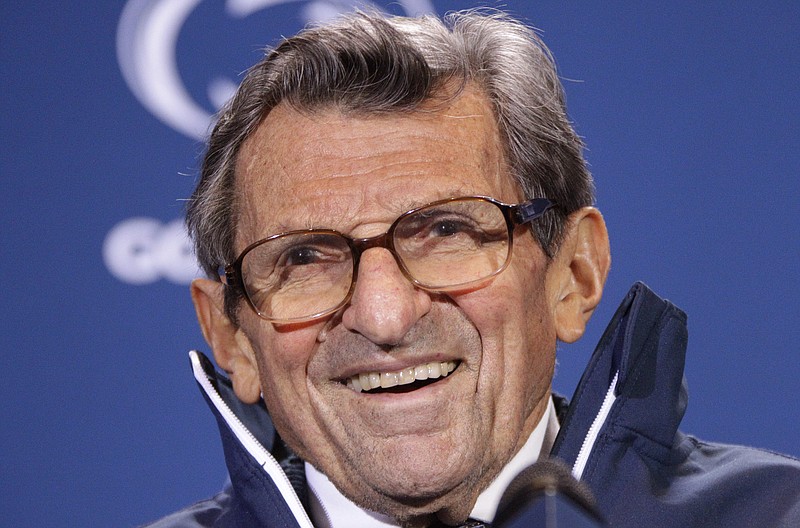 
              FILE - In this Oct. 29, 2011, file photo, Penn State head coach Joe Paterno smiles as he talks with reporters after recording his 409th career coaching victory, a 10-7 win over Illinois, during a a post-game NCAA college football news conference in State College, Pa.  A proposed settlement, announced Friday, Jan. 16, 2015, by the NCAA, will give Penn State back 112 football team wins that were vacated two years ago in the Jerry Sandusky child molestation scandal.  If approved, the new agreement also would restore former coach Paterno's status as the winningest coach in major college football history with 409 victories.  (AP Photo/Gene J. Puskar, File)
            