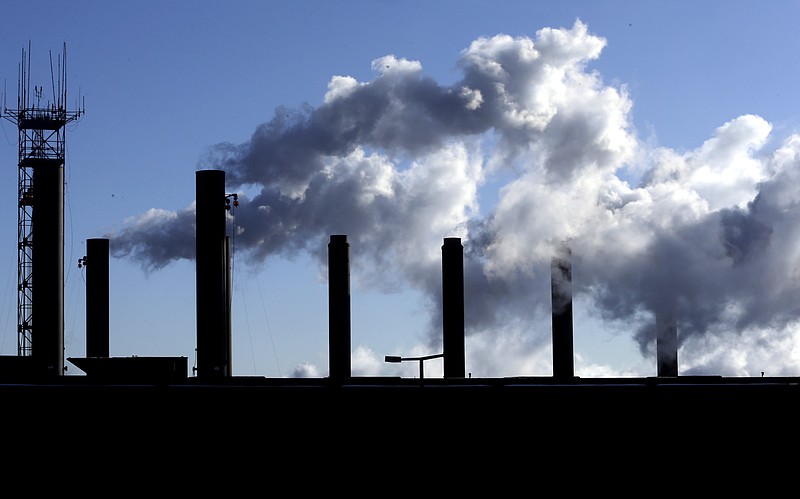 
              FILE - In this Jan. 7 2015 file photo, smoke emits from a factory chimneys near O'Hare airport in Chicago. The Federal Reserve releases industrial production figures for December on Friday, Jan. 16, 2015. (AP Photo/Nam Y. Huh, File)
            