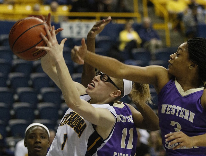	Staff photo by Doug Strickland
UTC guard Alicia Payne (1) rebounds the basketball away from Western Carolina's Sherae Bonner (11) and Kyia Hough (3) during the Mocs' game against the Western Carolina Catamounts on Saturday, Jan. 17, 2015, at McKenzie Arena in Chattanooga.