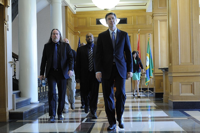 Mayor Andy Berke walks from his office with David Kennedy, left and Paul Smith, back center, to a press conference inside City Hall in file file photo.