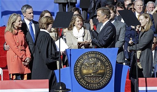 Tennessee Gov. Bill Haslam is sworn in by State Supreme Court Chief Justice Sharon Lee, left, during the inauguration for his second term Saturday, Jan. 17, 2015, in Nashville. First lady Crissy Haslam, center, holds the Bible.